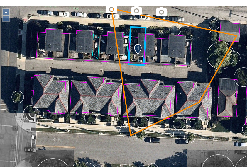 Aerial imagery of a rowhouse block with the geocoded pin on one highlighted unit and outlines around the parcel and buildings