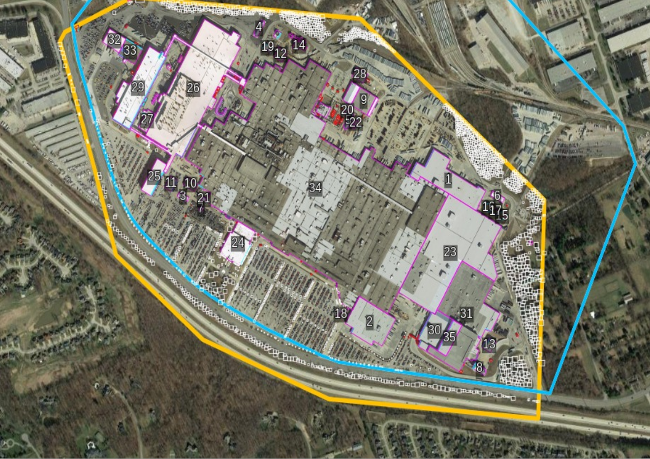 Aerial imagery of a retail parcel with the parcel polygon and 35 numbered building footprints outlined